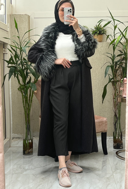 A Woman wearing a Black abaya with faux fur lining, paired with a matching Sheila headscarf