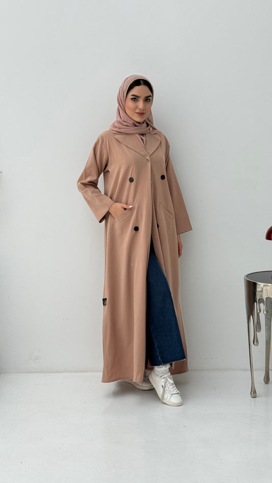 Woman wearing a long Beige Pinstripe Linen Coat Abaya, and a matching sheila on a white background