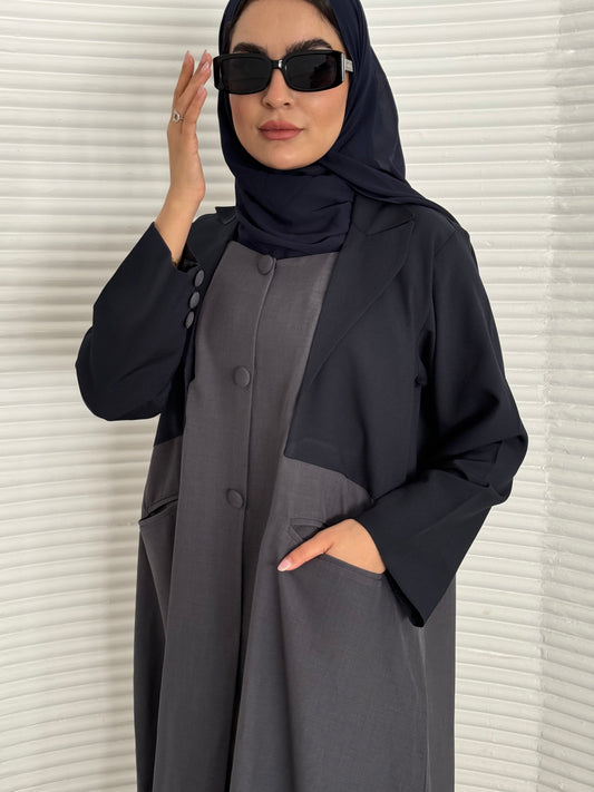 A navy blue and grey abaya, tailored from Linen, it features a coat-style collar and pockets for a structured fit.