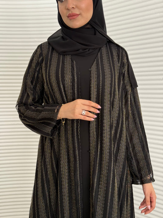 A 3 set of black and gold abaya, that includes a matching inner dress and sheila, this set is perfect for effortless evening luxury.