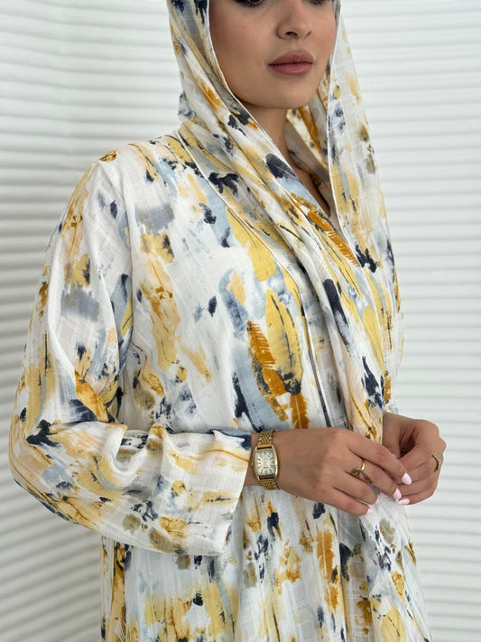 A yellow printed satin abaya, an elegant abaya that is perfect for summer, daytime events, artistic gatherings.