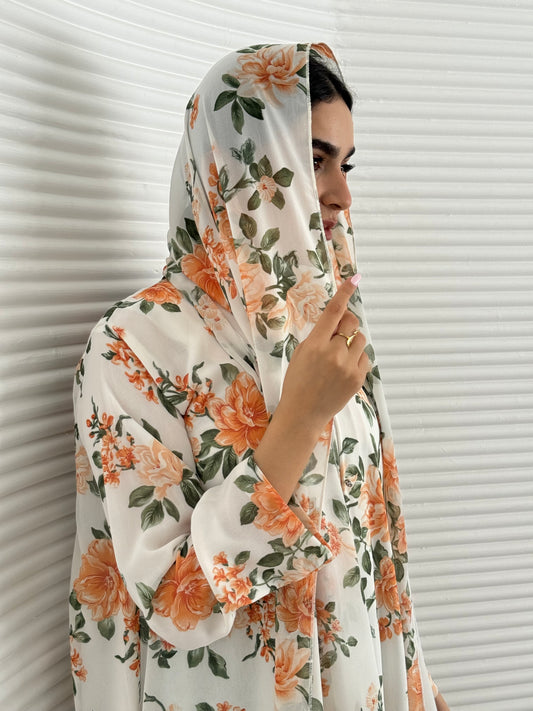 A white and orange floral chiffon abaya, an elegant abaya that is perfect for summer, daytime events, and brunch.