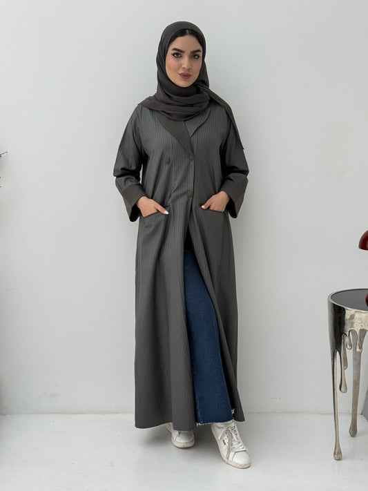 Woman wearing a long Dark Olive Pinstripe Linen Coat Abaya with a hood against a white background