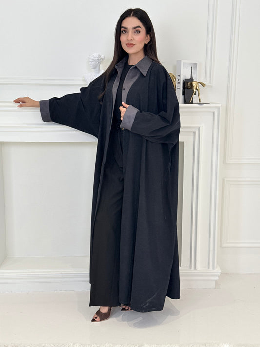 A woman wearing a Navy Blue with Grey Contrast made from Premium Ice Cool Fabric in a white room.