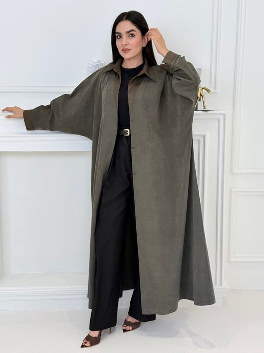 A woman wearing a Olive with Brown Contrast made from Premium Ice Cool Fabric in a white room.