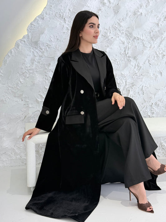 Woman wearing a Premium Black Velvet coat abaya on a light gray background