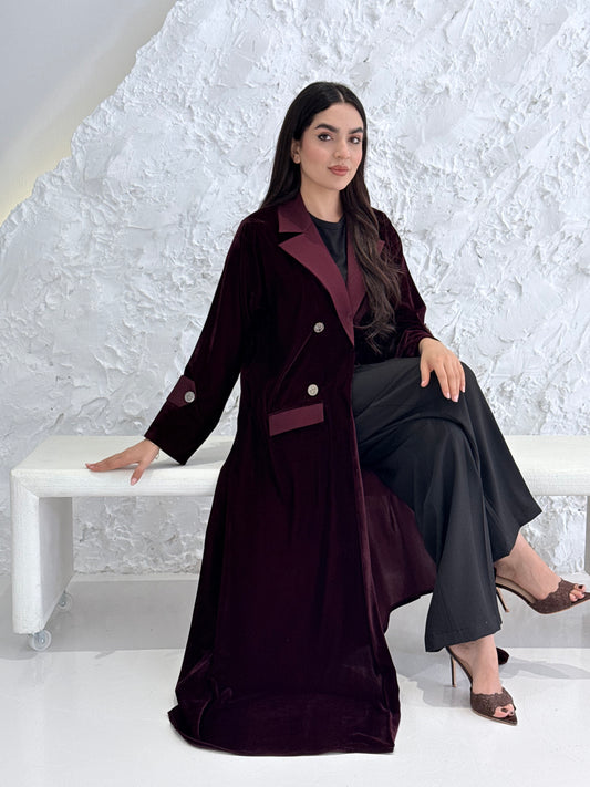 Woman wearing a Premium maroon Velvet coat abaya on a light gray background