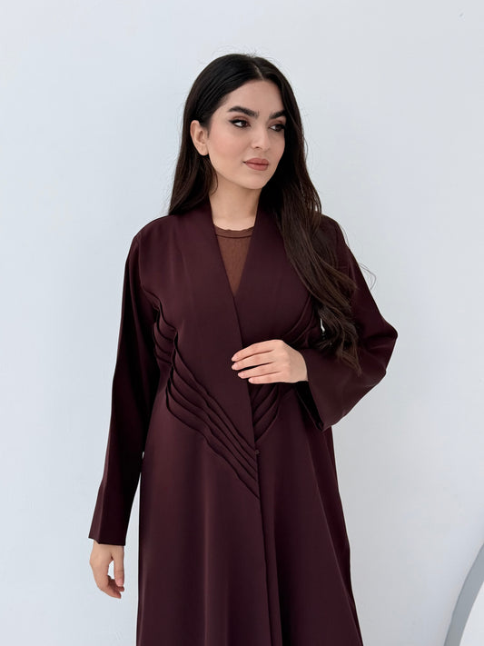 Woman wearing a long Premium burgundy Maroon Crepe Abaya with Pleated Waist dress on a white background