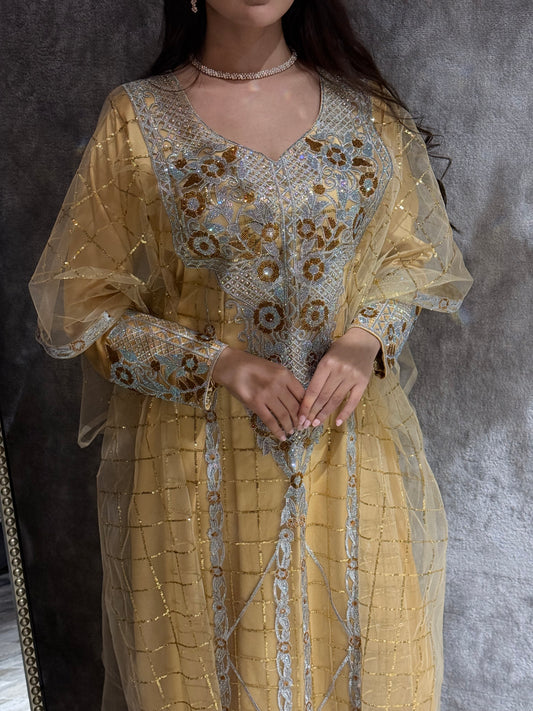 Close-up of a person wearing Yellow Emirati Design Tulle Dresson a gray background
