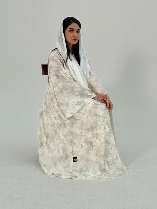 A woman wearing a Off-White printed abaya with long sleeves and a round neckline.