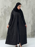 A woman wearing a Black Abaya with floral patterns Scattered Embellishments and a matching Sheila