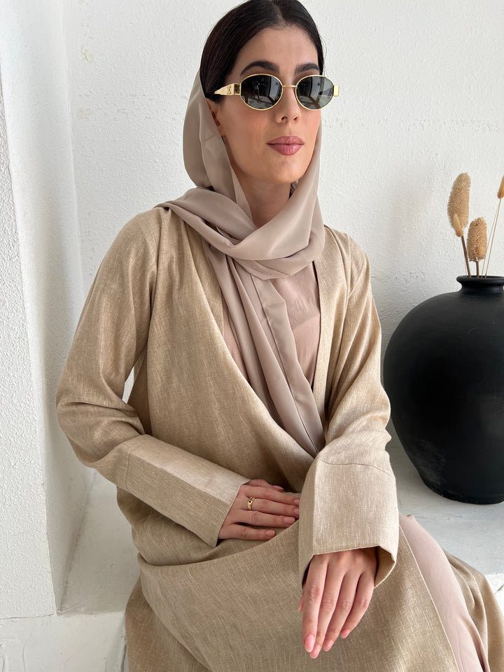 A woman wearing a Light Brown Linen Abaya with inner dress and a matching Sheila