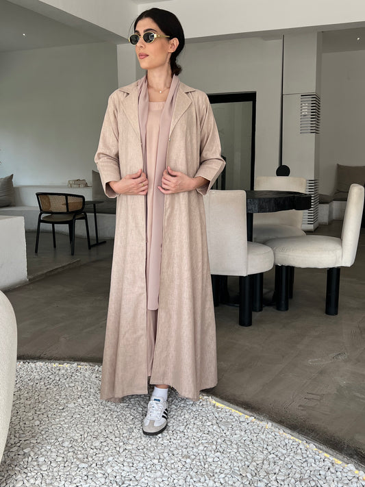 A woman wearing a Rose Beige Linen Abaya with inner dress and a matching Sheila