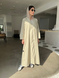 A woman wearing a Sage Green Linen Abaya with inner dress and matching Sheila