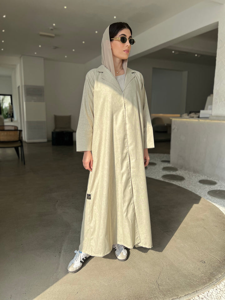 A woman wearing a Sage Green Linen Abaya with inner dress and matching Sheila