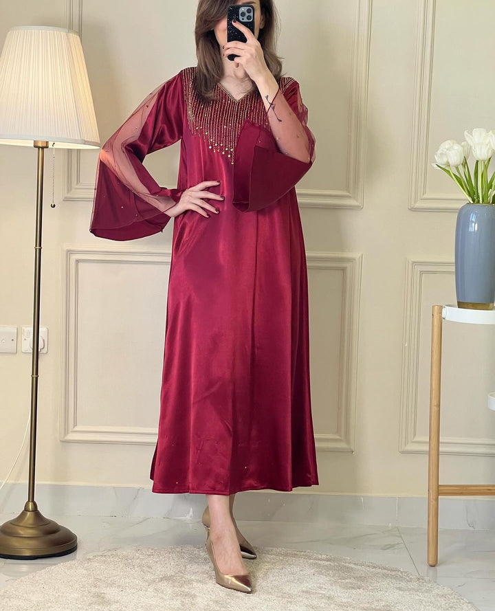 A woman wearing a Maroon Satin Embellished Dress