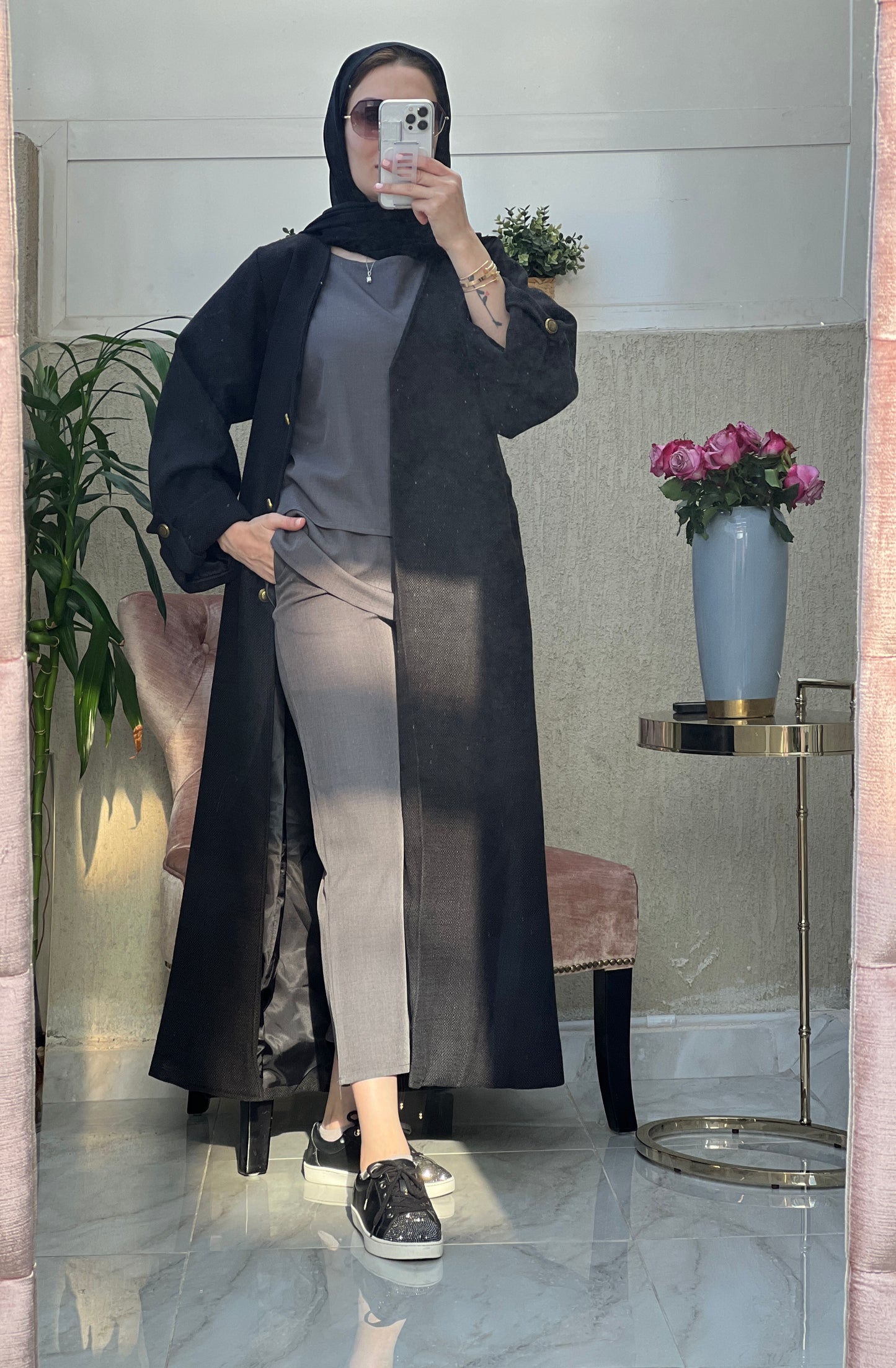 A woman wearing an Open front bisht-style abaya with embellished inner dress and matching Sheila