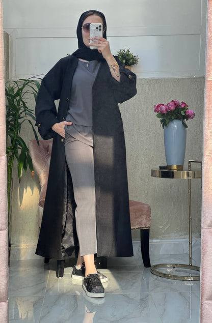 A woman wearing an Open front bisht-style abaya with embellished inner dress and matching Sheila