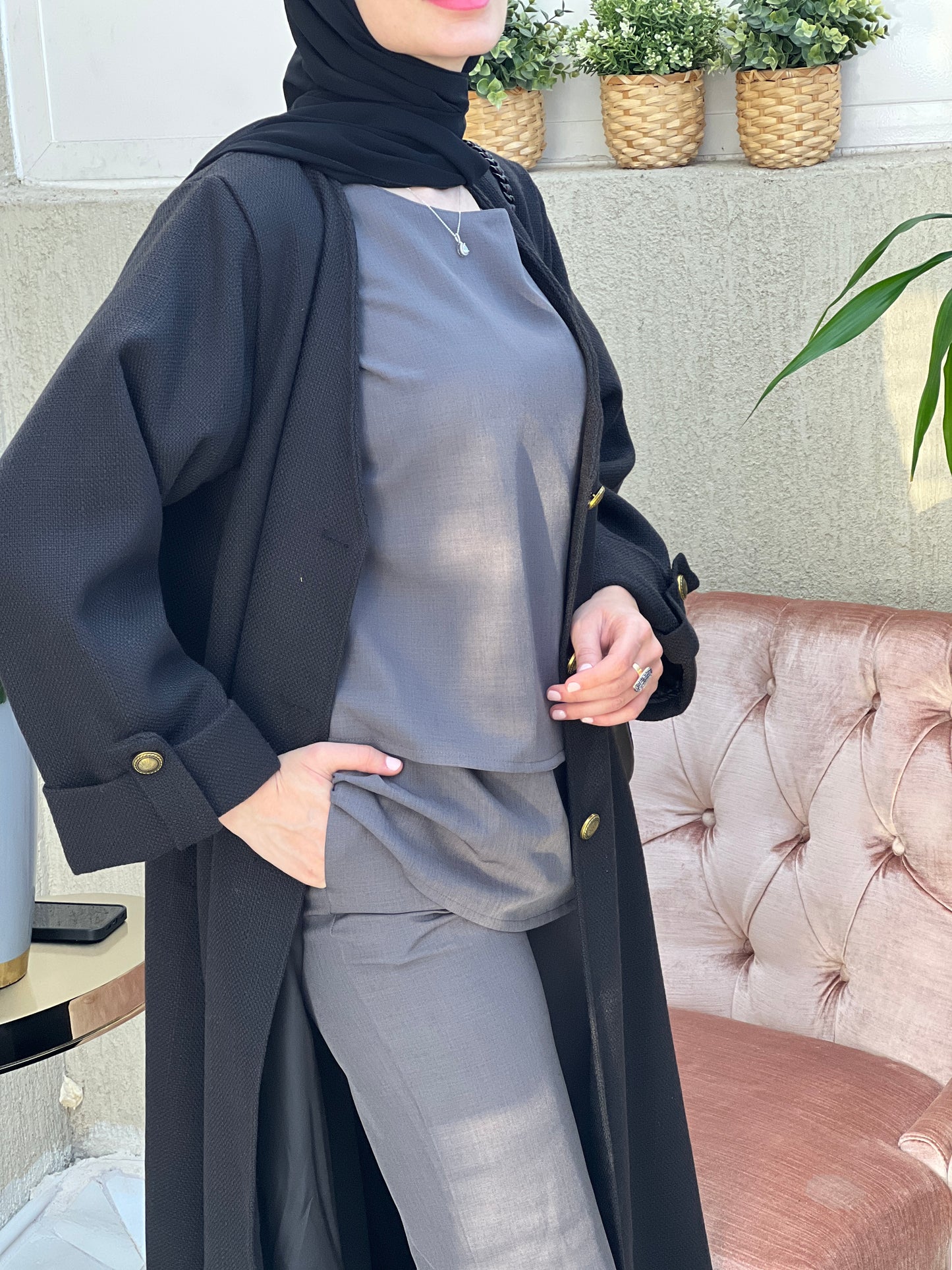 A woman wearing an Open front bisht-style abaya with embellished inner dress and matching Sheila