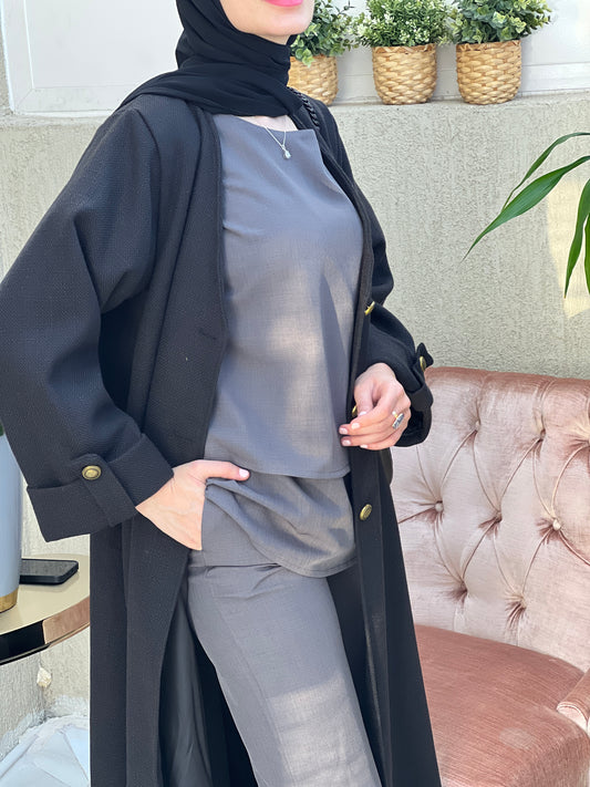A woman wearing an Open front bisht-style abaya with embellished inner dress and matching Sheila