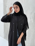 A woman wearing a Black Pinstripe Linen Coat Abaya with a striped pattern, featuring a hood and button-down front.