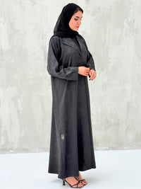 A woman wearinng a Black Floral Printed Satin Coat Abaya with lapel collar and matching Sheila