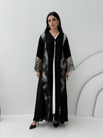 Woman wearing a Black Floral Lace Panel Abaya with a matching sheila against a white background