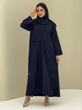 A woman wearing a navy blue Coat style with a lapel collar, Button-front, welt pockets, buttoned cuffs, and a matching sheila
