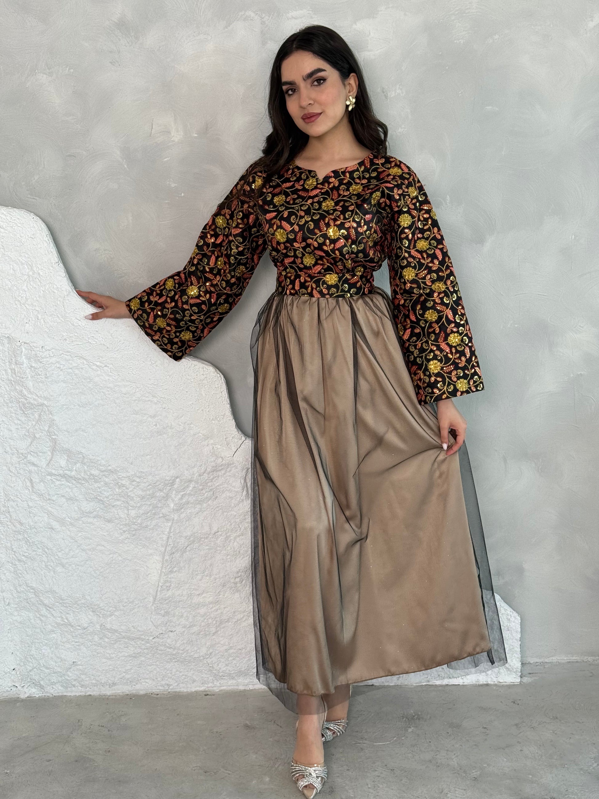 A woman wearing a floral long-sleeve Black & Gold Embroidered Tulle Dress