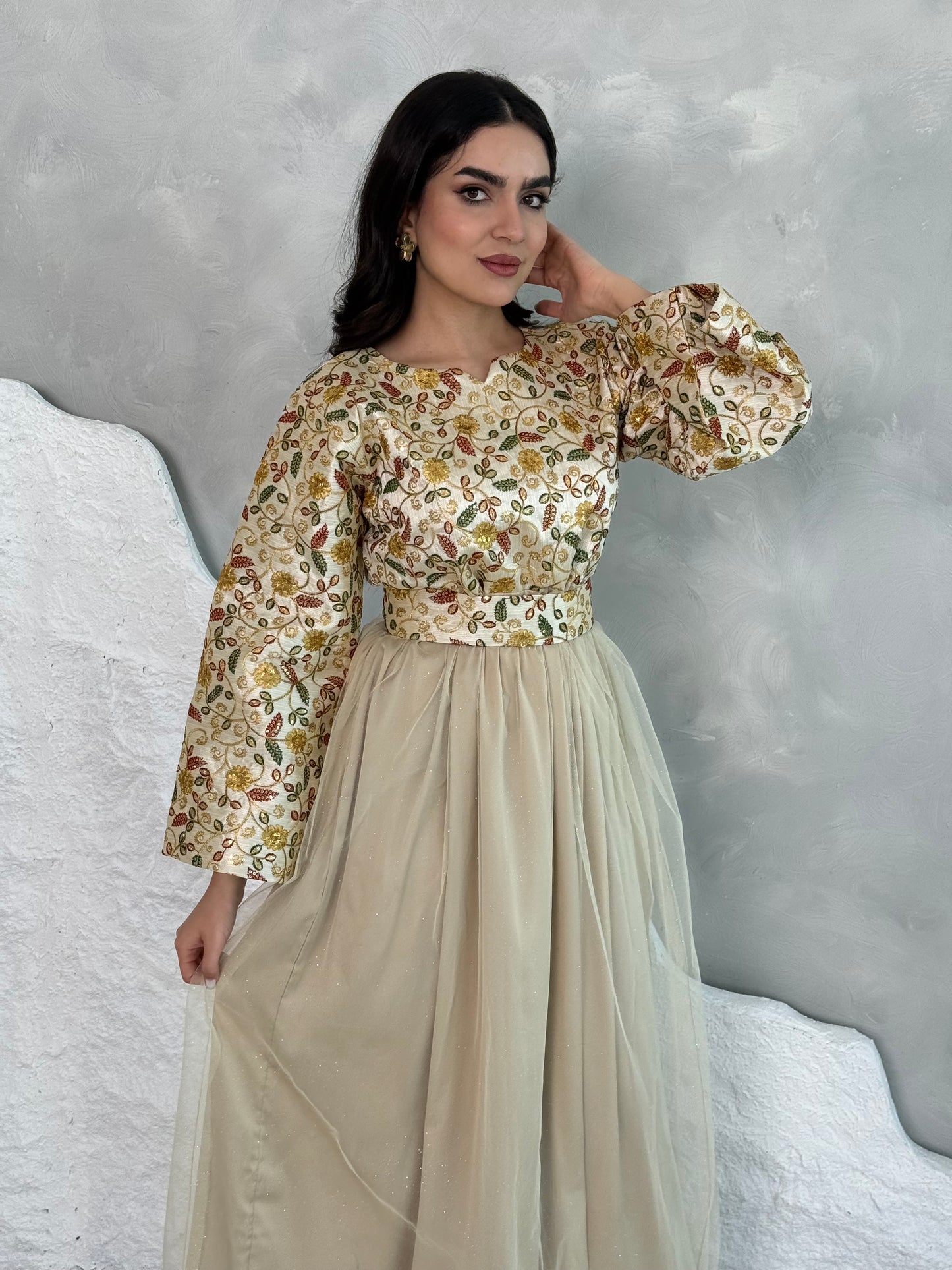 A woman wearing a floral long-sleeve  Cream Floral Embroidered Dress
