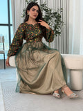 A woman wearing a floral long-sleeve  Dark Green Embroidered Tulle Dress