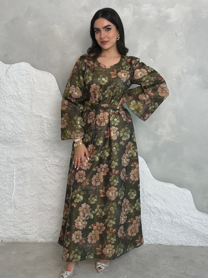 A woman wearing a dark olive green Floral Print Organza with Sequin Embroidery dress with long sleeves and a round neckline.