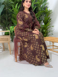 A woman seated in a garden setting, wearing an A-line brown Paisley Dress with Bishop Sleeves with gold embroidery and a netted veil.