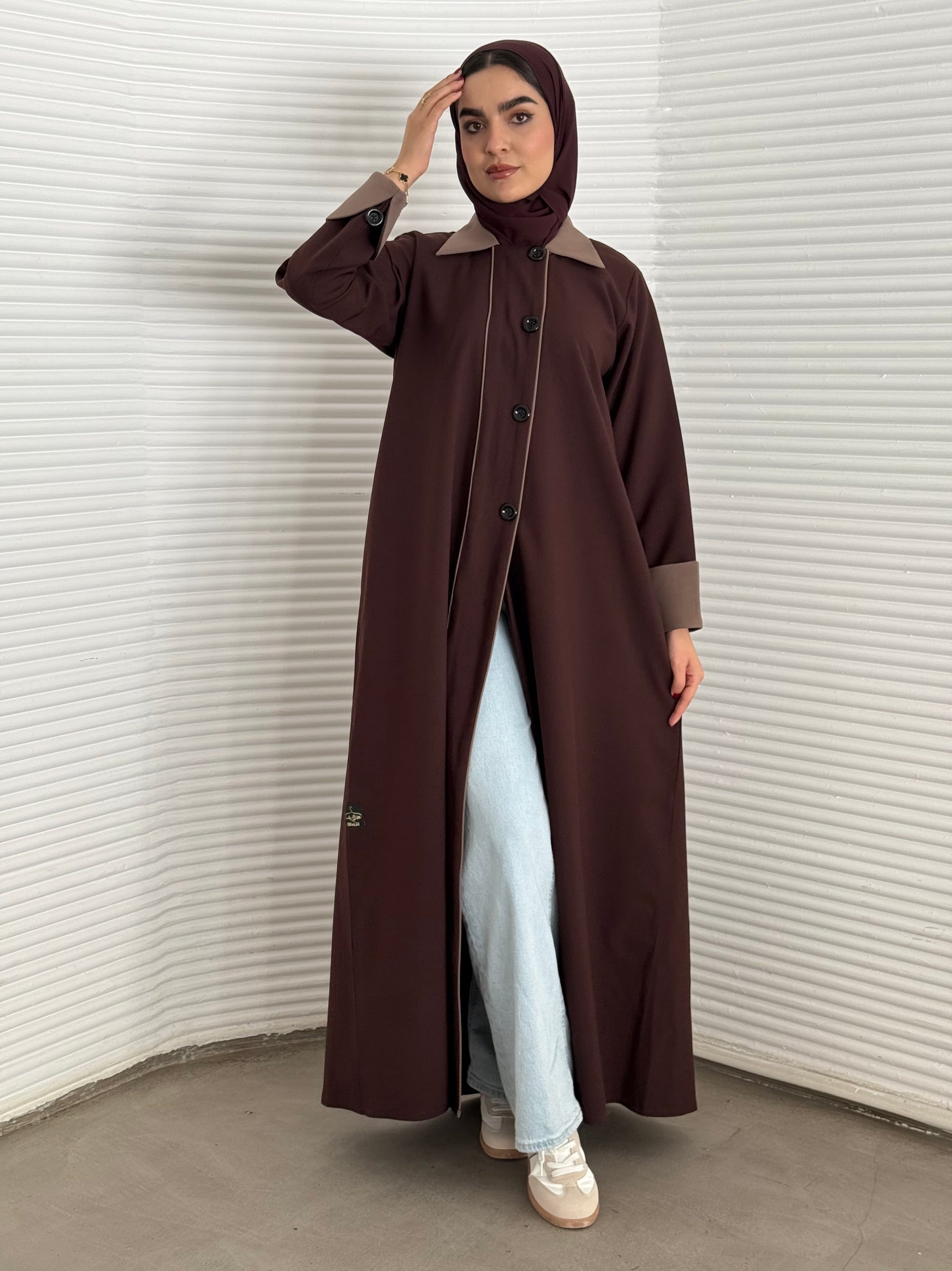 A dark brown abaya a linen fabric coat-style abaya, perfect for office wear, university and corporate events.
