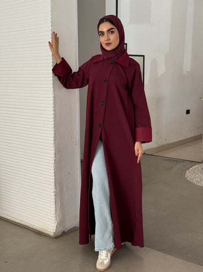 A maroon abaya of a coat-style, the abaya is perfect for office wear and corporate events.