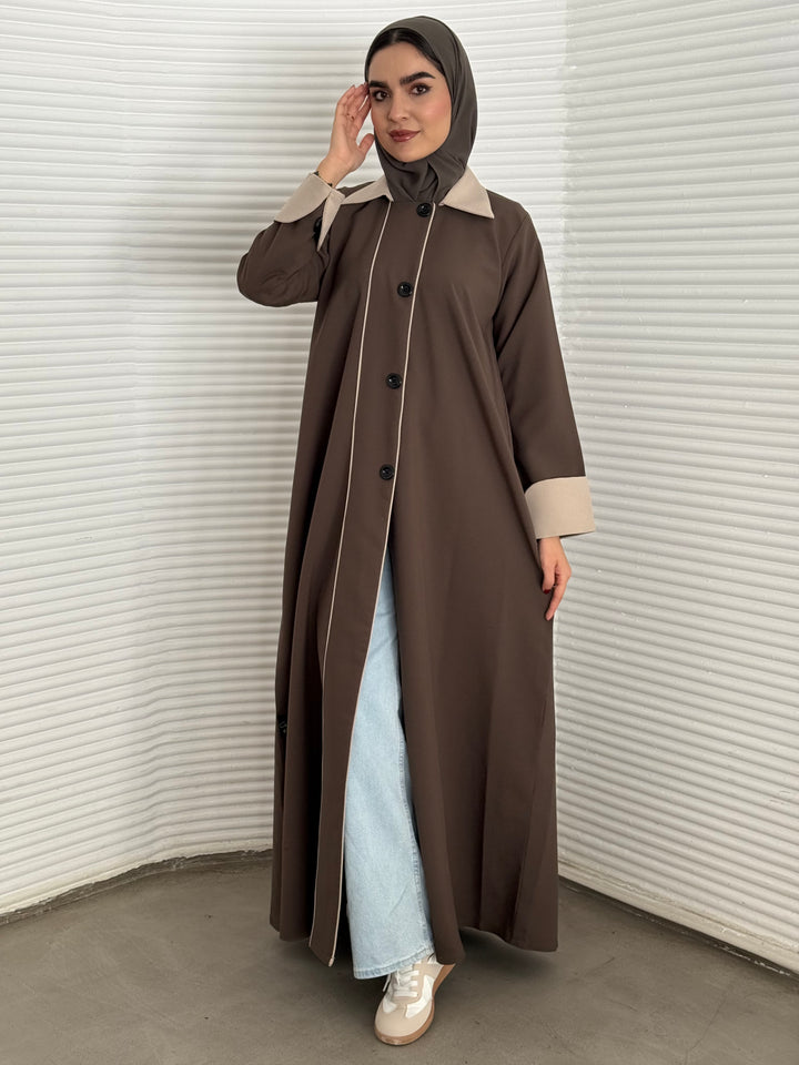 An olive abaya of a coat-style, the abaya is perfect for office wear and corporate events.