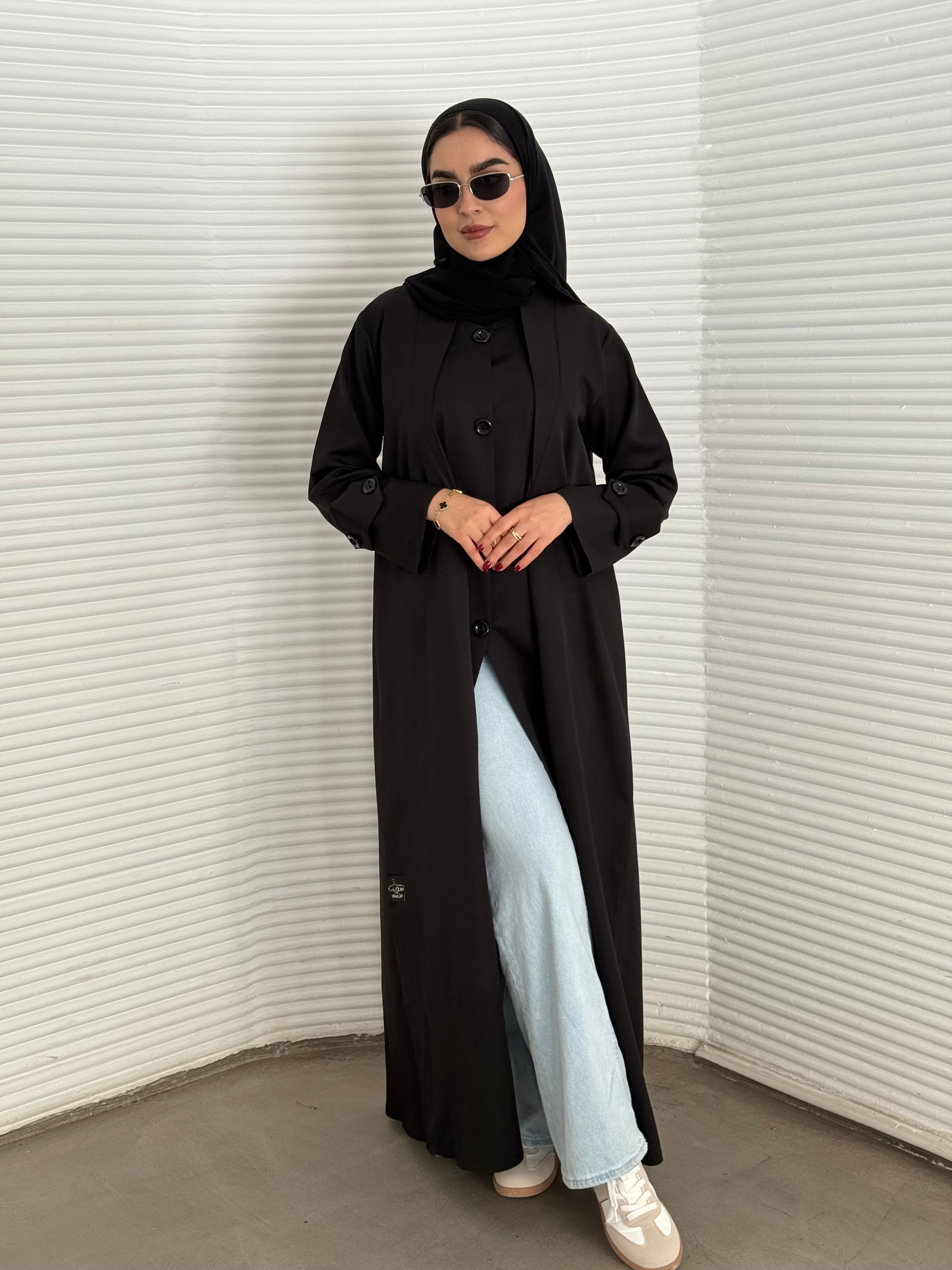 A black abaya, coat-style of a premium linen abaya, perfect for travel and office wear.