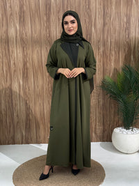 An olive green coat-style abaya is good for the office, boardroom, or an evening dinner and travel.