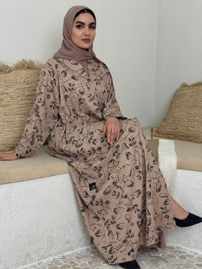 A light brown floral abaya that is perfect for office, evening wear, and events.