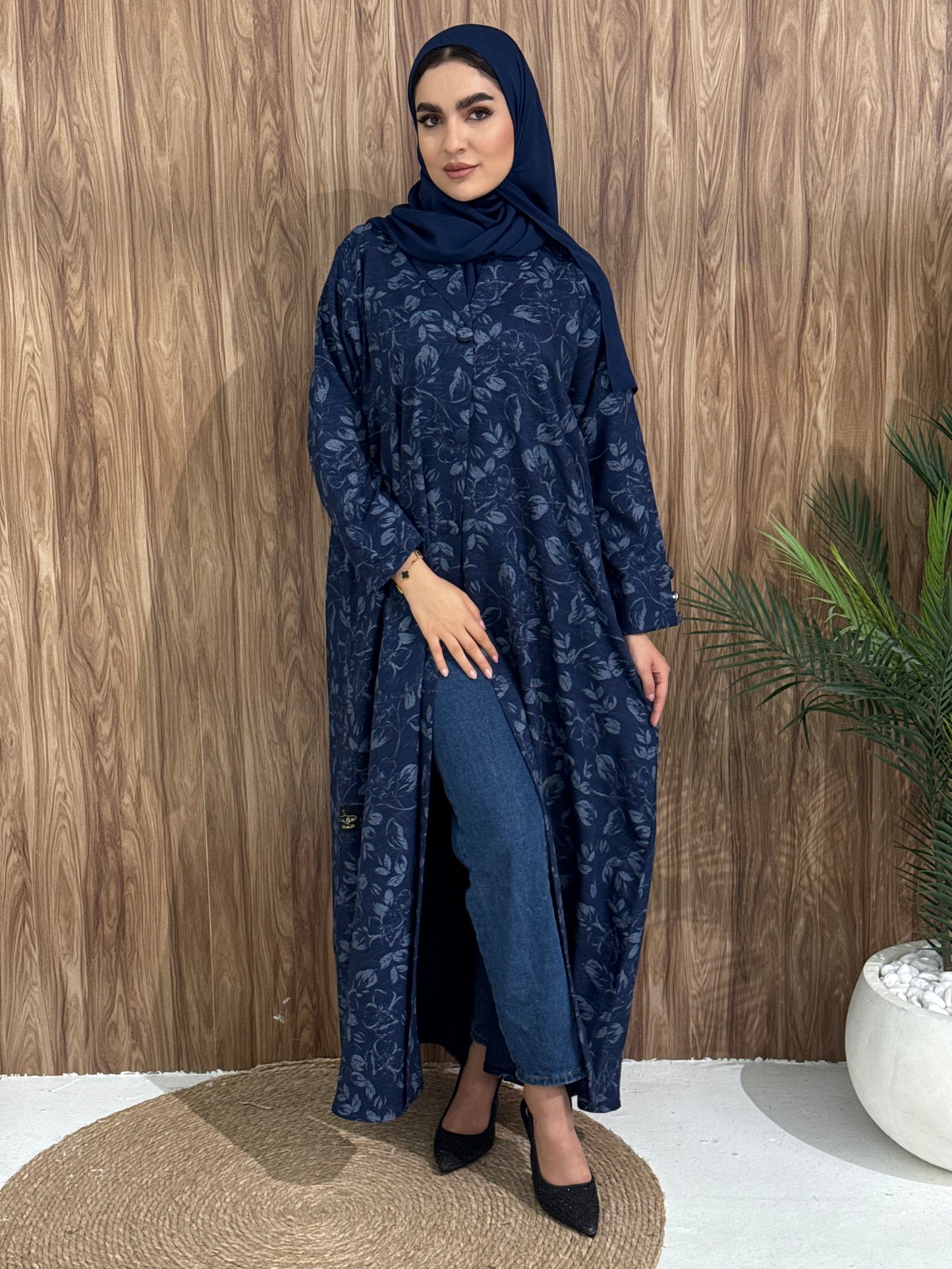 A navy blue floral abaya that is perfect for office, evening wear, and events.