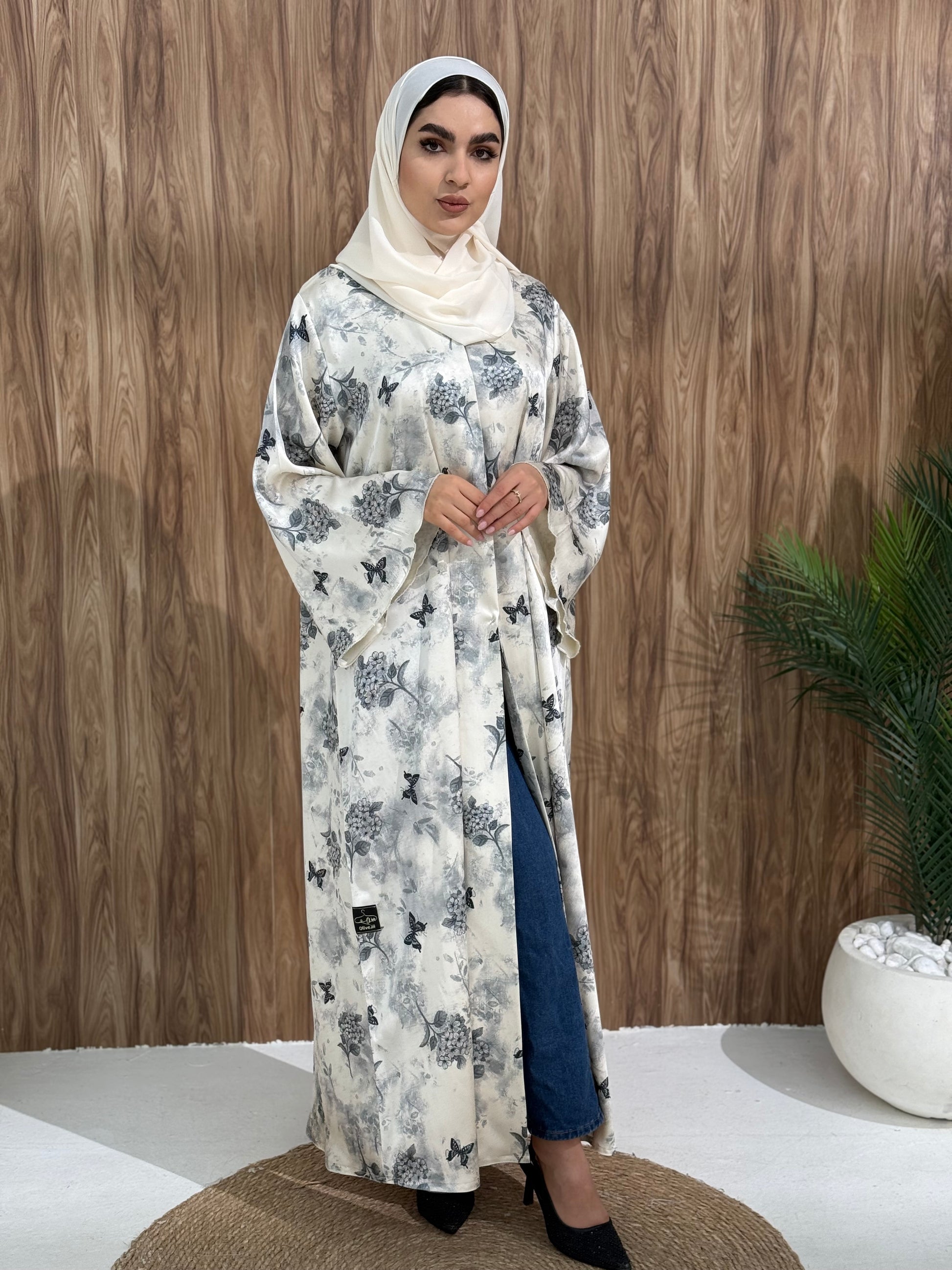 A stunning white butterfly abaya with a satin floral print, that is perfect choice for evening gatherings or  stylish daytime wear. 