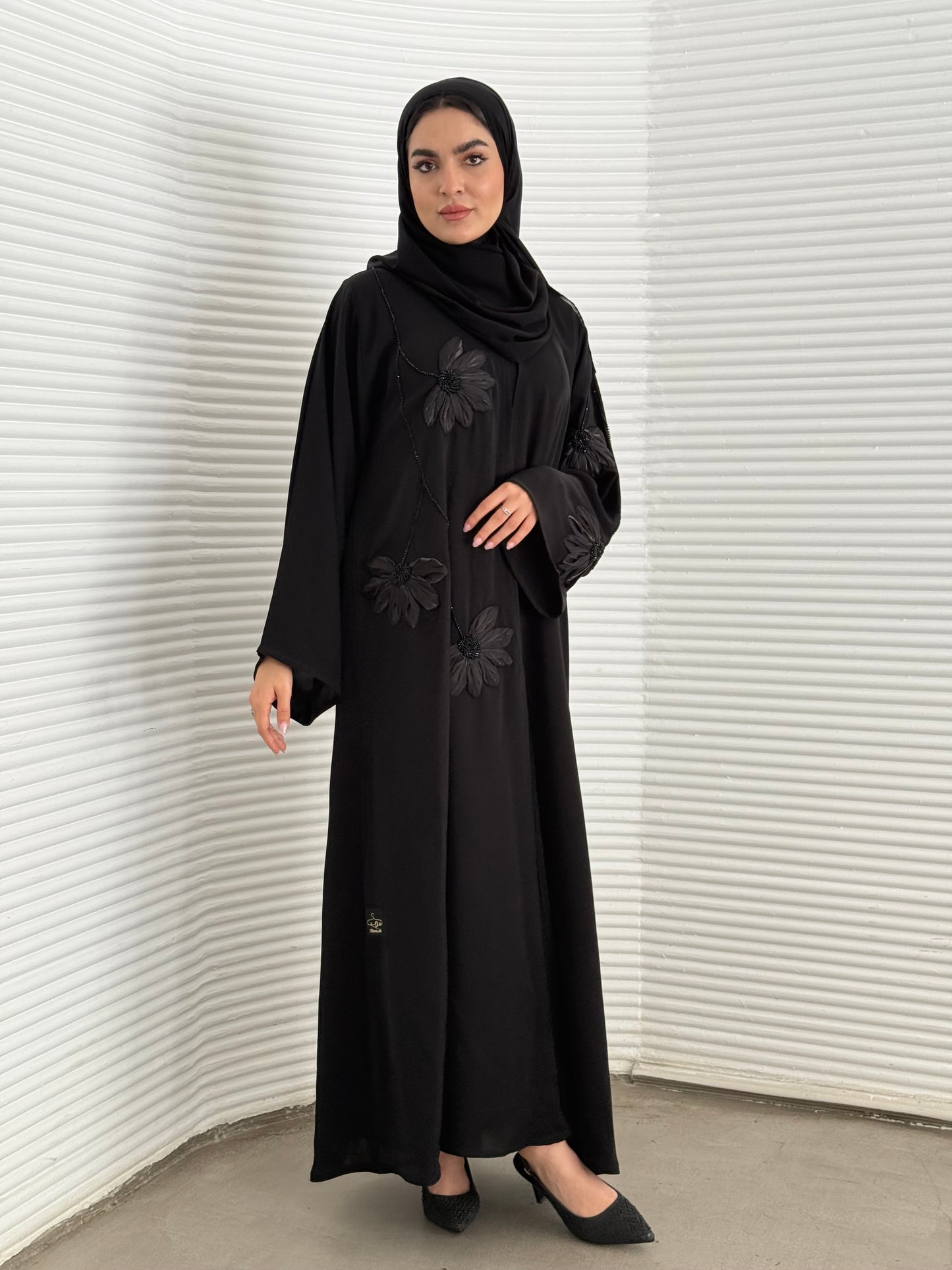 A black abaya, created /designed with a premium Nida fabric perfect for evening events.