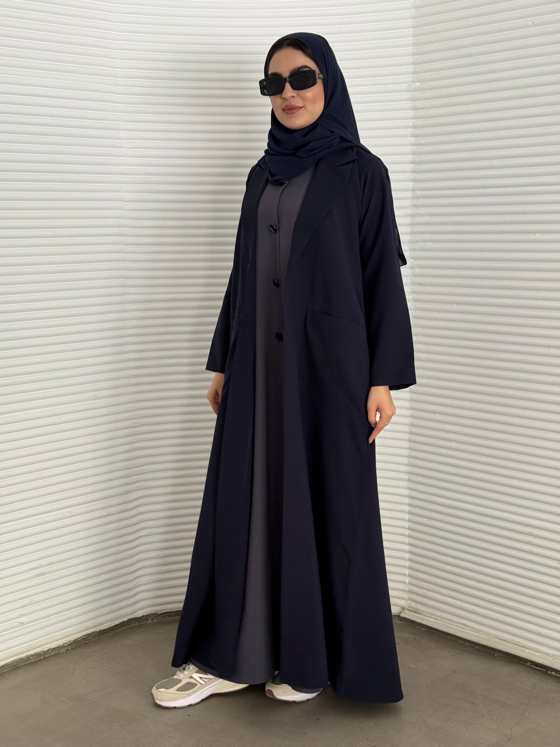 A premium linen navy blue abaya with a matching sheila, perfect for formal occasions and travel.