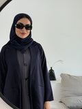 A premium linen navy blue abaya with a matching sheila, perfect for formal occasions and travel.