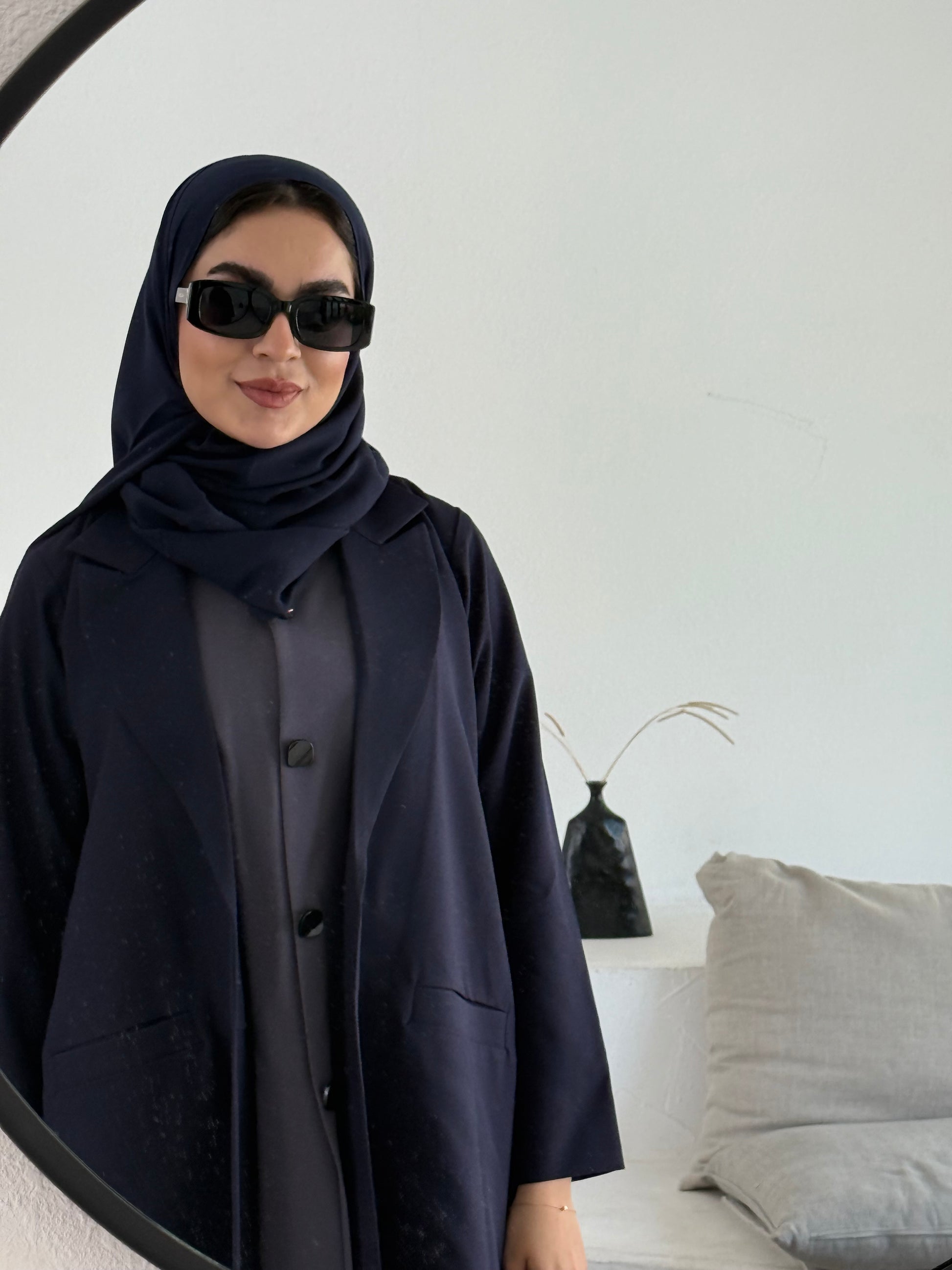 A premium linen navy blue abaya with a matching sheila, perfect for formal occasions and travel.