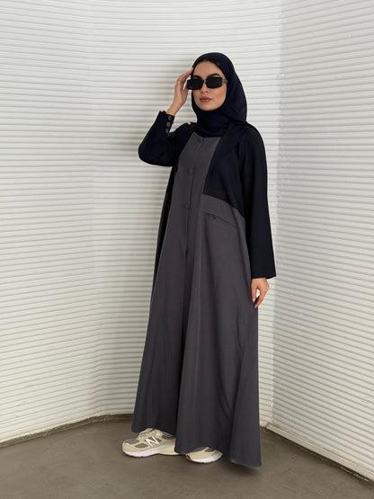 A navy blue and grey abaya, tailored from Linen, it features a coat-style collar and pockets for a structured fit.