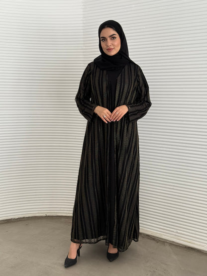 A 3 set of black and gold abaya, that includes a matching inner dress and sheila, this set is perfect for effortless evening luxury.