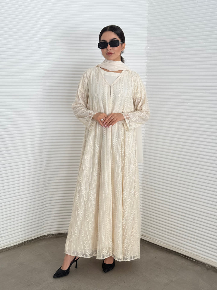 A 3 set of cream abaya, that includes a matching inner dress and sheila, this set is perfect for effortless evening luxury.