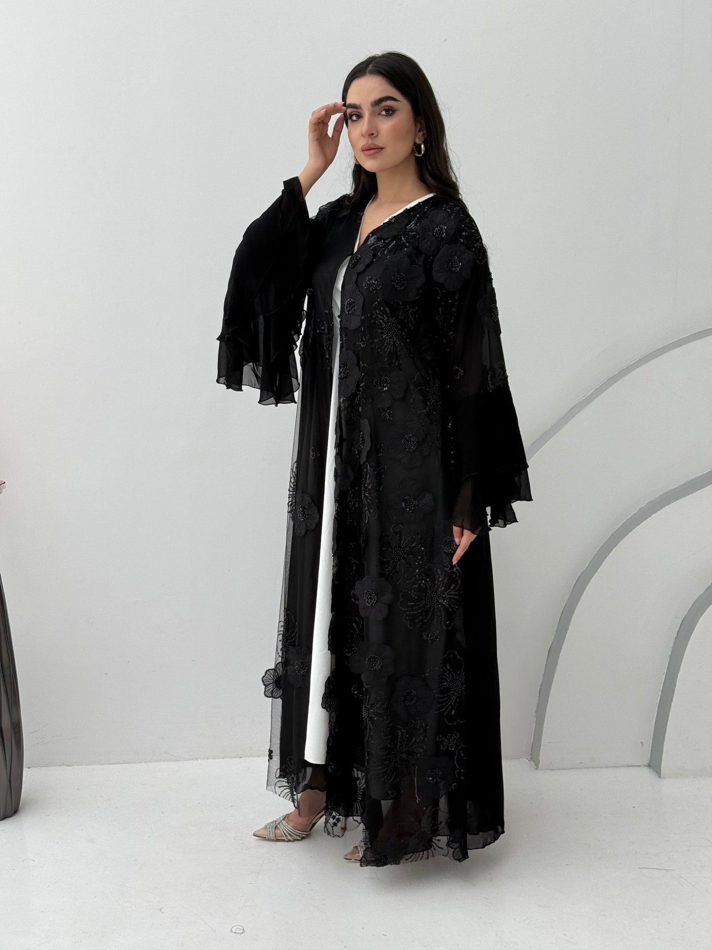 A luxurious black abaya with chiffon and texture of Black floral lace. This abaya is perfect for evening outings and occasions.