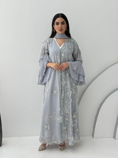 A luxurious light grey abaya with chiffon and texture of Black floral lace. This abaya is perfect for evening outings and occasions.